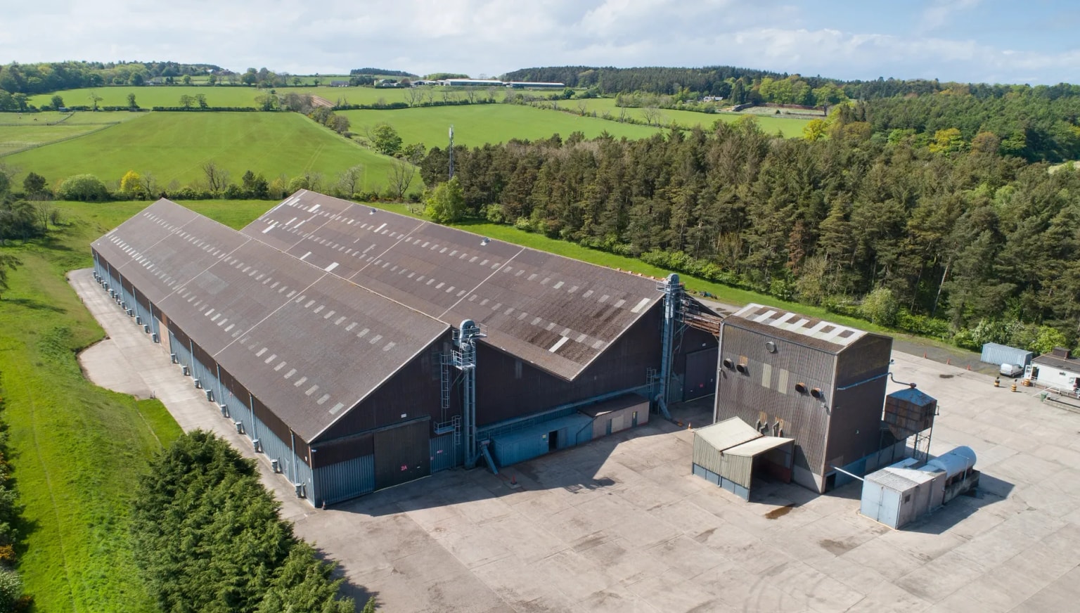 Aerial photo of North East Grains storage facility, with large grains sheds and grain drying equipment